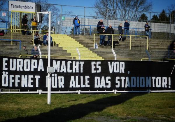 „Europa macht es vor, öffnet für alle das Stadiontor!“-Plakat am Zaun des Bruno-Plache-Stadions.